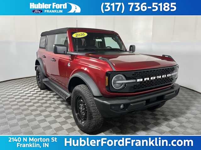 2026 Ford Bronco Outer Banks in Ruby Red Metallic Tinted Clearcoat — front three-quarter view